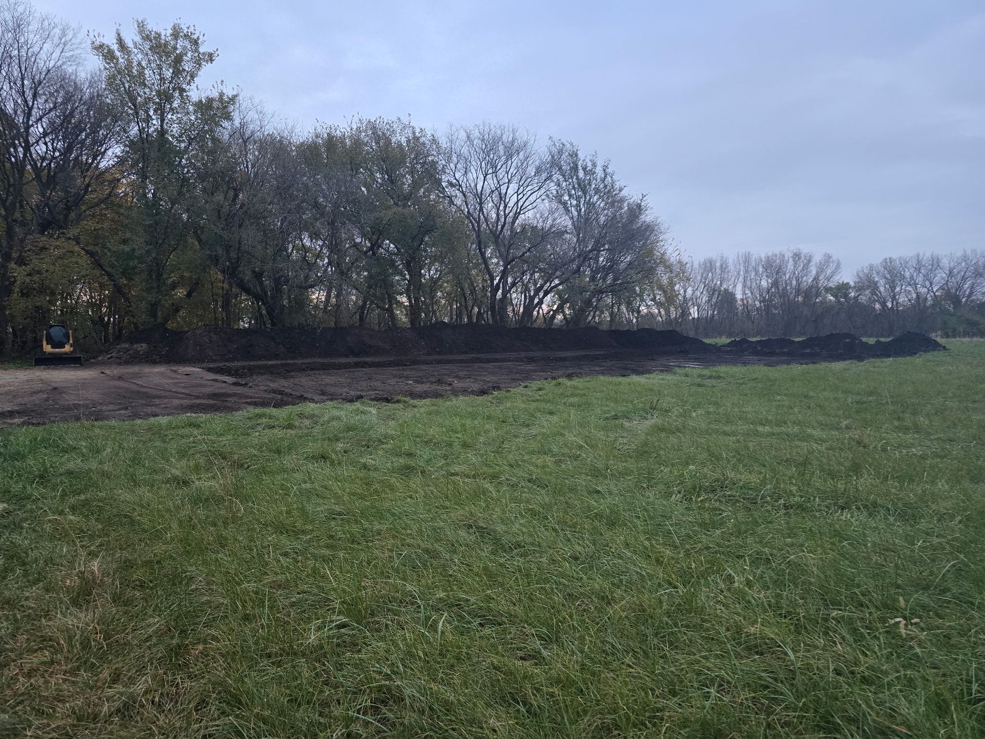 Open Minnesota field before a custom pole barn build begins