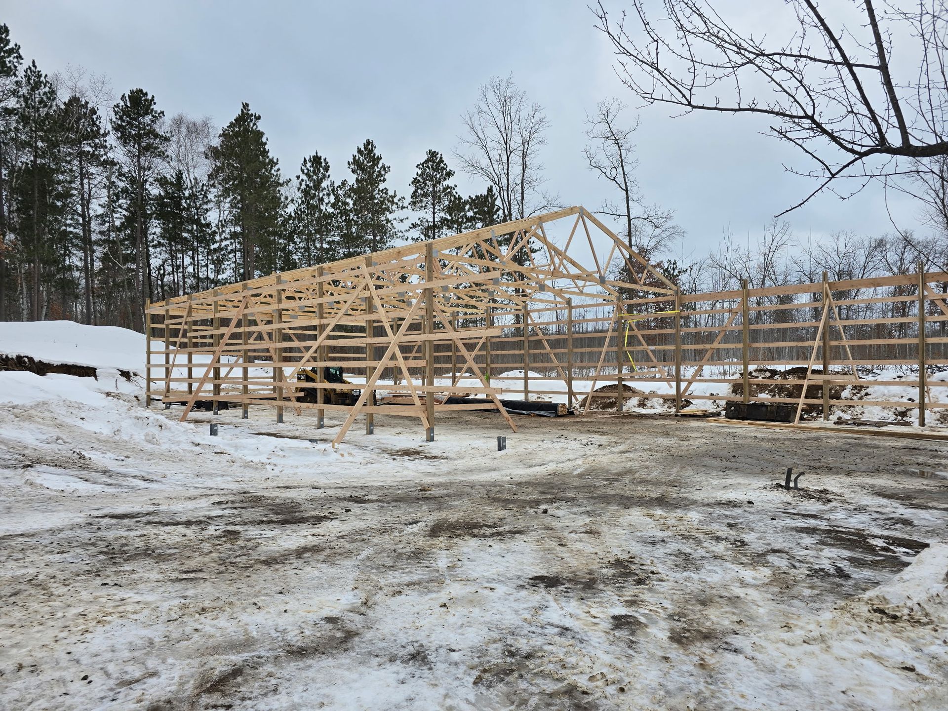 Pole barn frame erected in winter before roofing