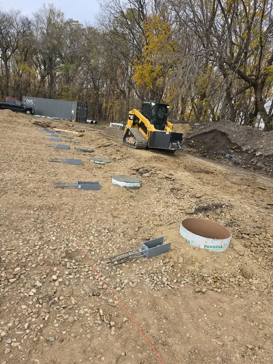 Crew setting pole barn foundation posts