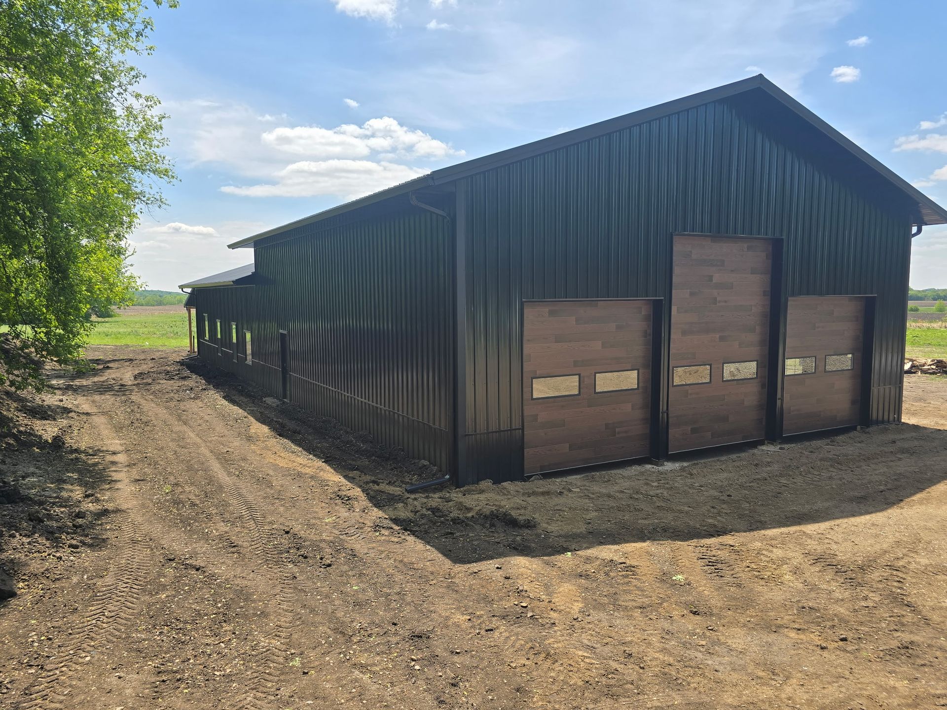 Custom Orton pole barn shop with tall bay doors